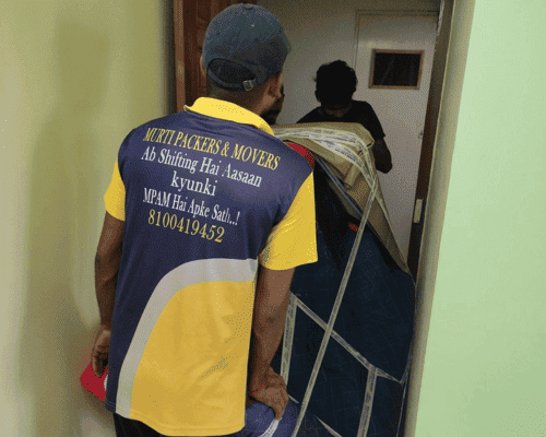 Murti Packers and Movers team safely moving packed household furniture during a home shifting service in Kolkata using professional handling techniques.
