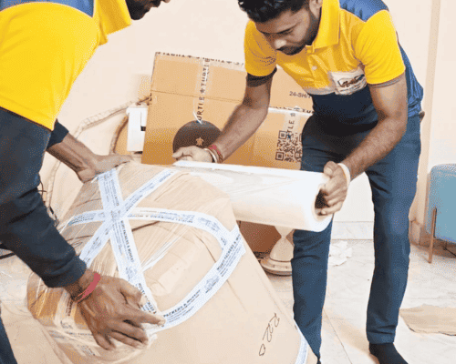 Professional packers and movers in Bolpur safely packing household furniture with protective wrapping materials